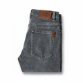Men's grey washed denim jeans folded on white background
